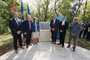 Left to right: Jim Walker, Dave Mowat, Lieutenant Governor Mitchell, City of Edmonton Councillor Tim Cartmell, Speaker of the Alberta Legislature Nathan Cooper and Elder Jerry Saddleback unveil the Walkway Marker at Govrenment House.